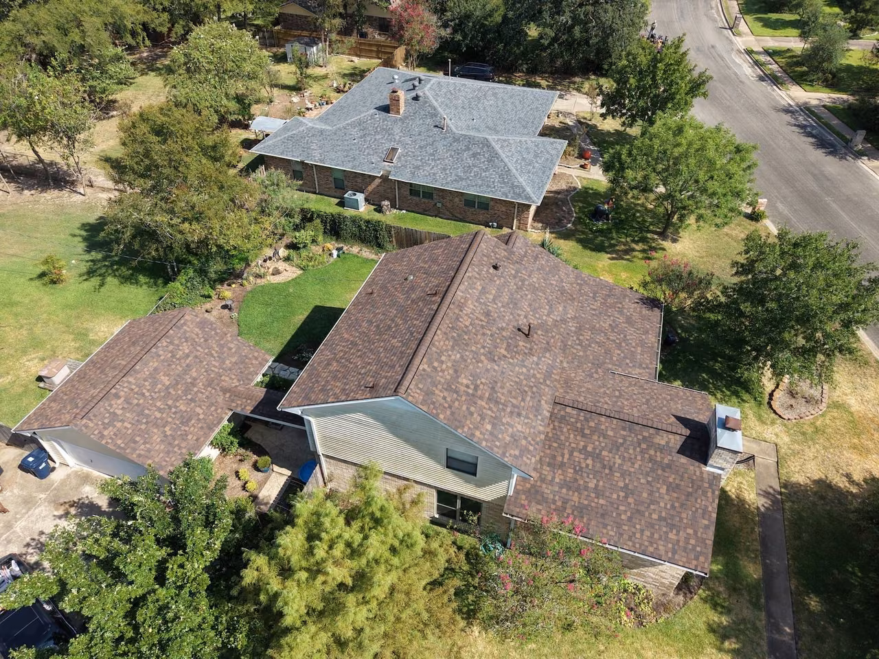 Aerial view of a home with a new brown shingle roof