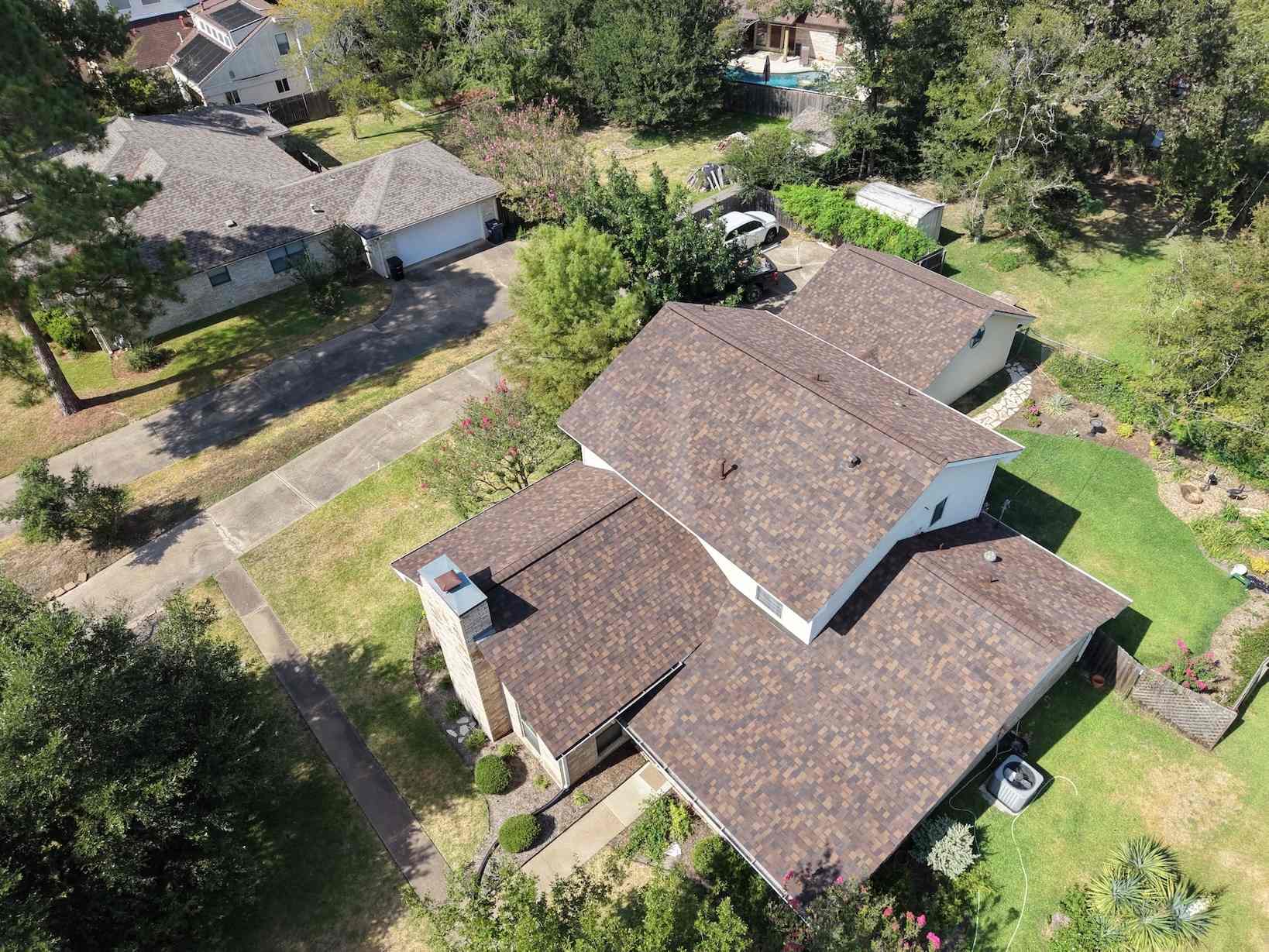 Aerial view of a home with a new brown shingle roof