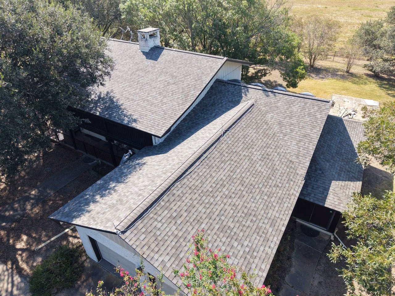 Aerial view of a home with a new gray shingle roof