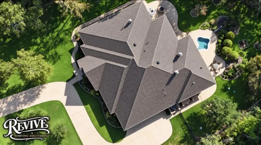 Aerial view of a luxury home with a new gray shingle roof