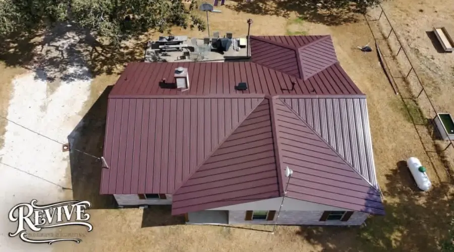 Aerial view of a burgundy metal roof on a country home