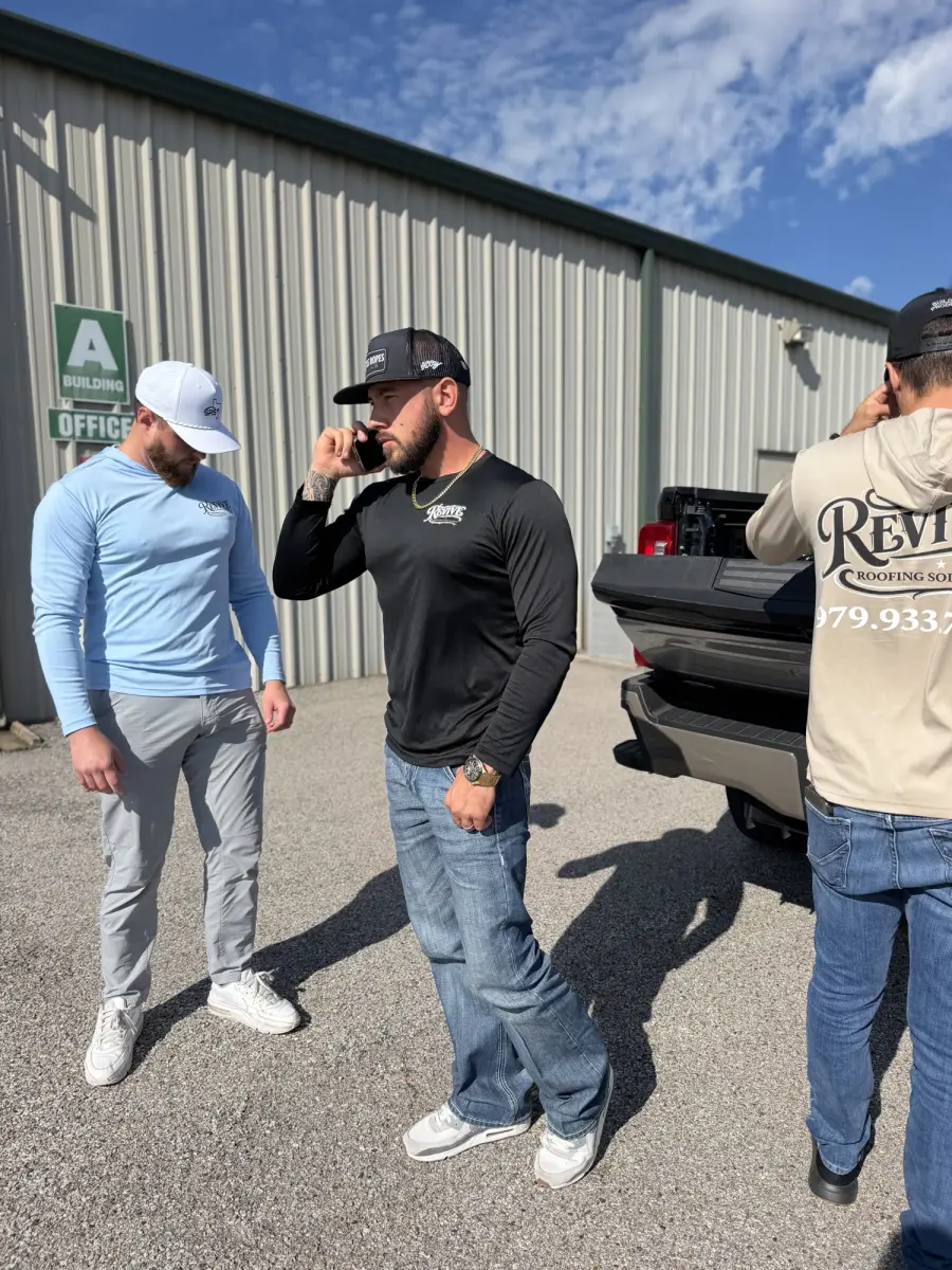 Revive team members talking in front of a work truck