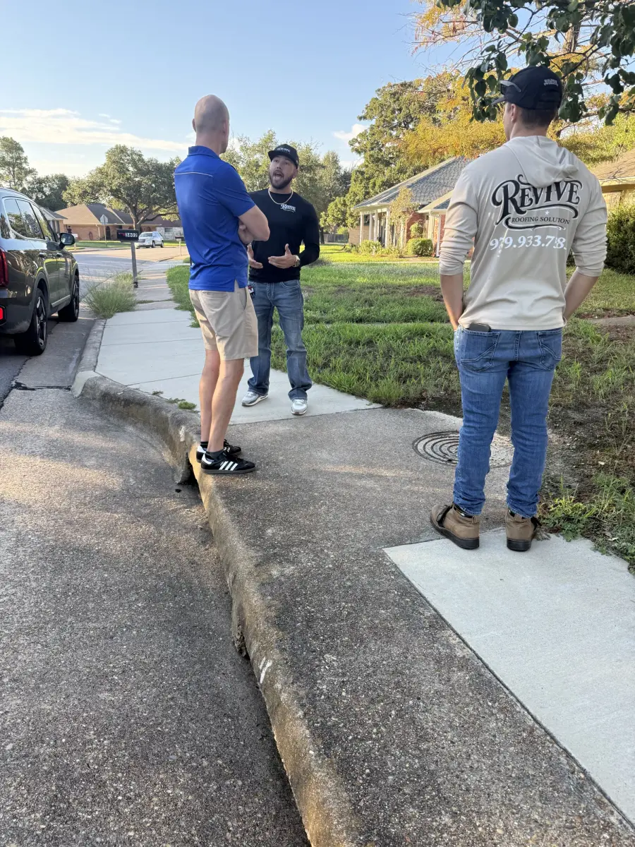 Revive team members meeting with a customer outside a home