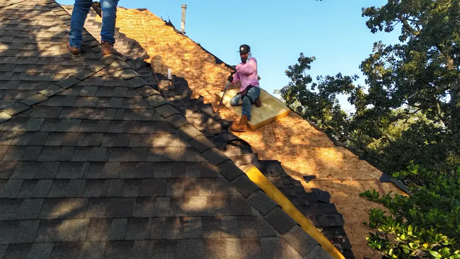 Crew member on a roof deck during a shingle installation