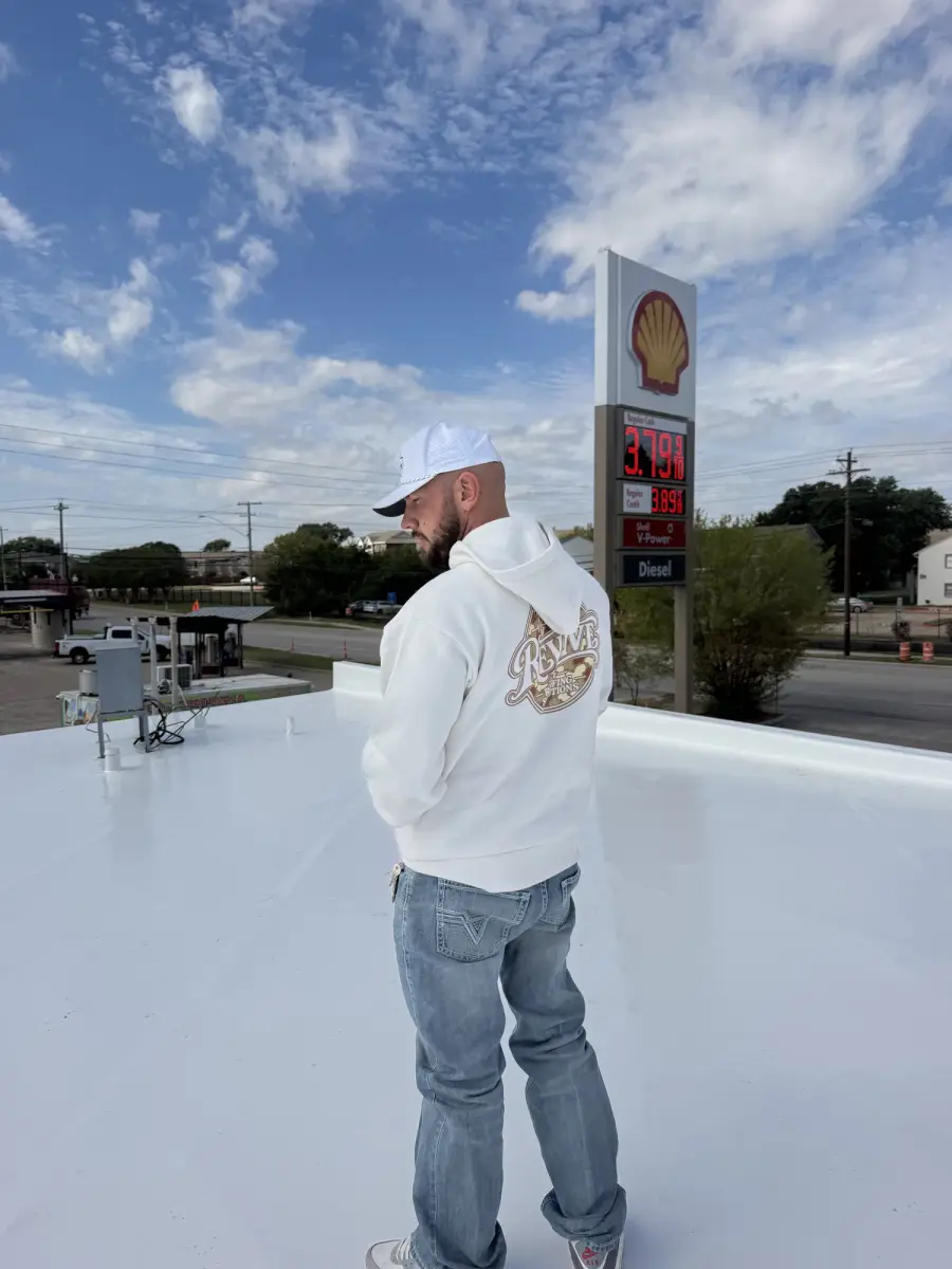 Revive team member on a newly finished white flat roof