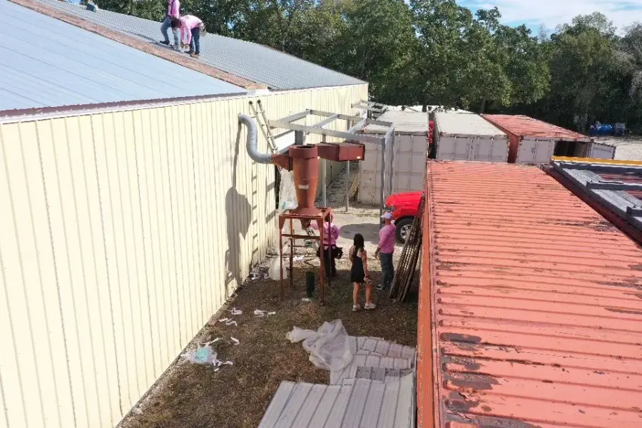 Revive crew members working along a commercial metal roof