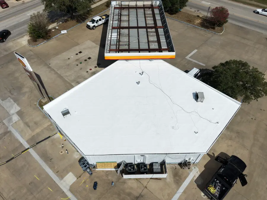Aerial view of a newly finished white flat roof on a commercial building